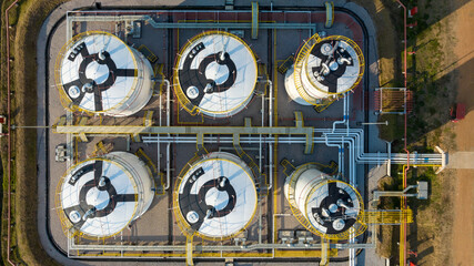 Aerial view white oil storage fuel tanks at oil depot station, White Industrial tanks for gasoline petrol and oil fuel with pipeline, Oil and gas industrial, Oil refinery plant industry.