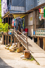 Fototapeta na wymiar A long wooden ramp up the side of rustic housing at Chau Doc in Vietnam