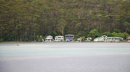 Waterfront houses along the Stony Creek in Burrill Lake, NSW, Australia.  