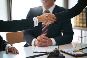 Lawyer consultant shaking hand with client sign contract agreement document. in law firm. Business meeting Handshake.  