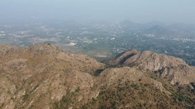 Bahubali Hills, Udaipur, Rajasthan, India 28th December 2022: Popular prewedding destination and trekking spot near Udaipur. 4k Aerial view of Bahubali hill and Badi lake near Barda village
