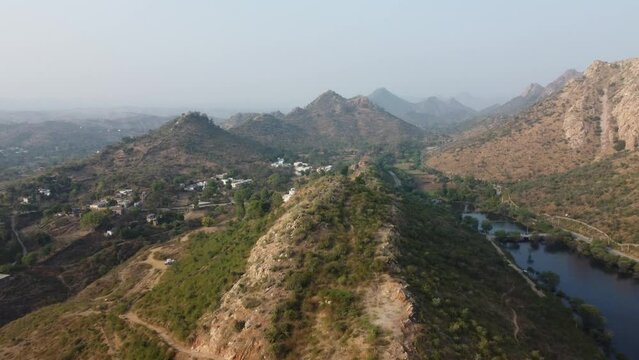 Bahubali Hills, Udaipur, Rajasthan, India 28th December 2022: Popular prewedding destination and trekking spot near Udaipur. 4k Aerial view of Bahubali hill and Badi lake near Barda village