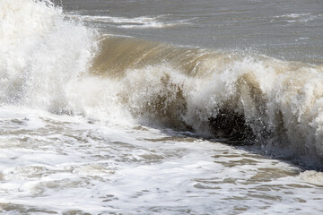 foamy coastal sea wave of a pebble beach