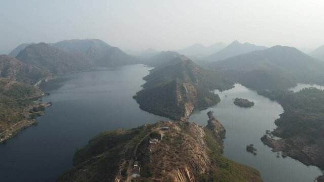 Bahubali Hills, Udaipur, Rajasthan, India 28th December 2022: Popular prewedding destination and trekking spot near Udaipur. 4k Aerial view of Bahubali hill and Badi lake near Barda village