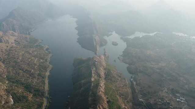 Bahubali Hills, Udaipur, Rajasthan, India 28th December 2022: Popular prewedding destination and trekking spot near Udaipur. 4k Aerial view of Bahubali hill and Badi lake near Barda village