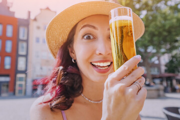 A girl drinks and tasting a delicious craft kind of traditional German and Cologne beer Kolsch in a...