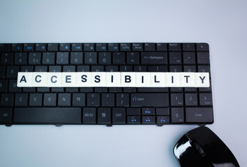 laptop keyboard with alphabet letters or the word accessibility. the concept of access or activated...