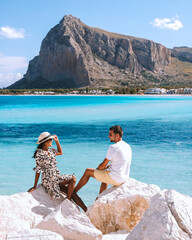 San Vito Lo Capo Sicilia, couple of men and woman visiting the beach of San Vito Lo Capo Sicily Italy - obrazy, fototapety, plakaty