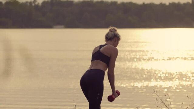 woman exercising outdoors to train muscles and improve strength	