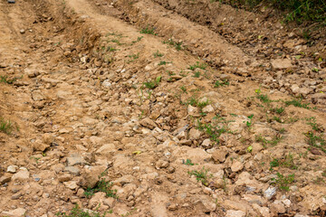 Stony clay soil on a country road close up