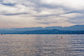Scenic view over Lake Zürich with Swiss Alps in the background on a blue cloudy autumn day. Photo taken October 30th, 2022, Zurich, Switzerland.