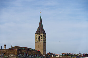 Fototapeta na wymiar Church tower of famous church St. Peter at the medieval old town of Zürich on a blue cloudy autumn day. Photo taken October 30th, 2022, Zurich, Switzerland.