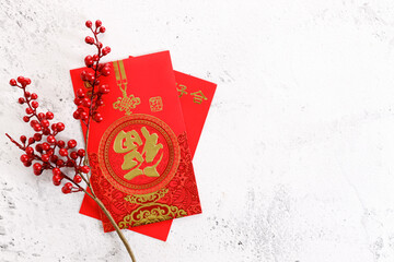 Chinese new year festival decorations with red bags, oranges and red Chinese folded fans on white marble table background.