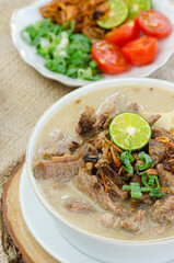 Close up of Indonesian Soto Betawi, Traditional Food with soup and meats