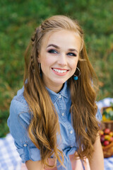 Fototapeta premium Portrait of a beautiful sweet young woman with long brown hair and a radiant dazzling smile