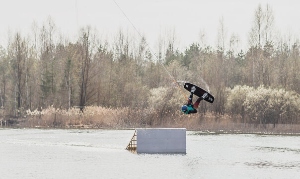 Wake Boarder Doing A Roll In Cable Wake Park