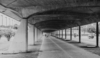 Black and white photo of under passage of bridge in Spain