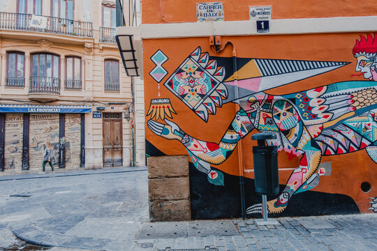 Street art painted on orange building corner in Spain
