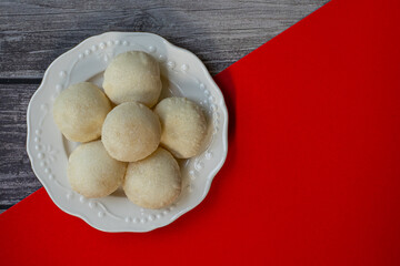 Phuket Thailand snack food, White Flaky Puff is a local dessert of Phuket. Originating from Hokkien Chinese, Popular to buy as a souvenir. Put a plate on an antique wooden table.