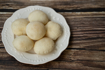 Phuket Thailand snack food, White Flaky Puff is a local dessert of Phuket. Originating from Hokkien Chinese, Popular to buy as a souvenir. Put a plate on an antique wooden table.