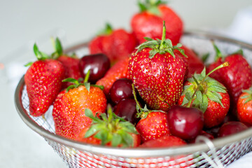 Strawberries and cherries in a metal basket