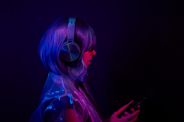 Woman in headphones listening music and enjoing