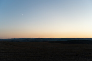sunset over the field and moon 