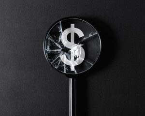 Obraz premium Inflation, economic crisis, financial problems, recession concept. Close-up of broken cracked magnifier glass focused on dollar sign on black background