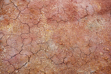 Red cracked clay. Natural earth texture