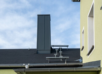 roof with chimney covered with metal sheet, plumber and roofer craft