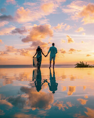 couple watching sunset at infinity pool Saint Lucia, couple on vacation tropical Island of St Lucia with beautiful reflection in pool - obrazy, fototapety, plakaty