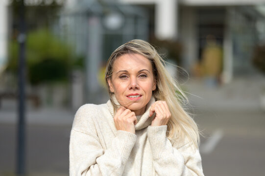 Middle Aged Woman In A White Turtleneck Sweater