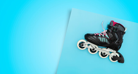Stylish roller skates on blue background, top view. Inline skates isolated on blue.