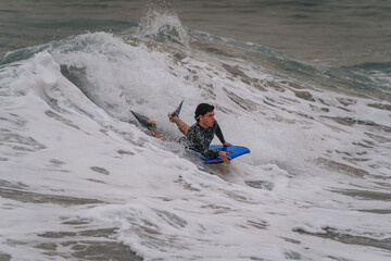 Naklejka premium young bodyboarder surfs a wave in Gran Canaria. Canary Islands. Spain