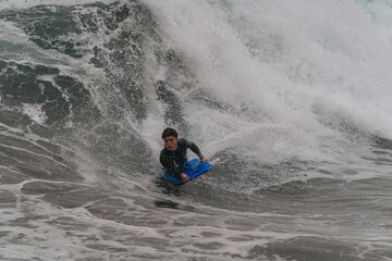 Fototapeta na wymiar young bodyboarder surfs a wave in Gran Canaria. Canary Islands. Spain