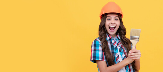 Renovation child, amazed kid with curly hair in construction helmet hold painting brush, renovator. Child builder in helmet horizontal poster design. Banner header, copy space.
