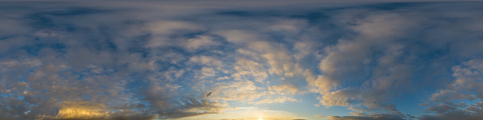 Panorama of a dark blue sunset sky with golden Cumulus clouds. Seamless hdr 360 panorama in spherical equiangular format. Full zenith for 3D visualization, sky replacement for aerial drone panoramas.