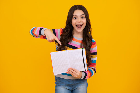 Amazed teenager. Teenage school girl with books. Schoolgirl student. Excited teen girl.