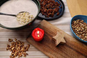 Sweet porridge with poppy seeds and raisins for Christmas by candlelight