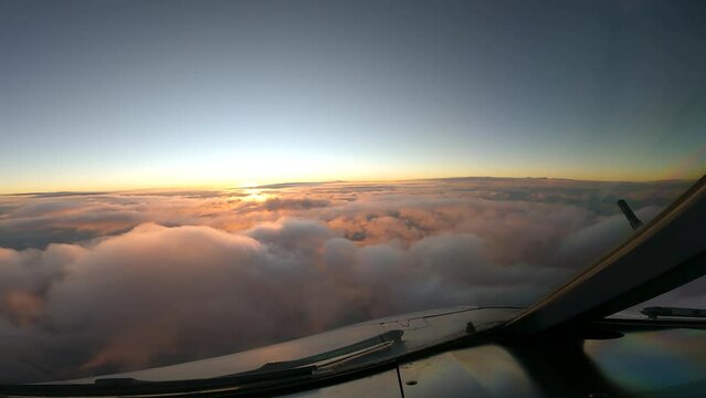 sunsite over the clouds in the sky cockpit view airplanes