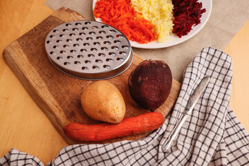 Boiled grated vegetables - carrots, potatoes, beets, on a plate