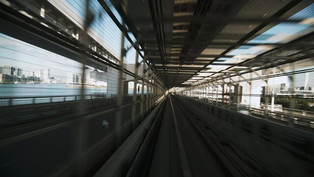 (Part 5 of 6) Point of view Yurikamome line automated train moving forward crossing Rainbow bridge to Odaiba in Tokyo, Japan. Advanced transportation system, Asia tourism, transport technology concept