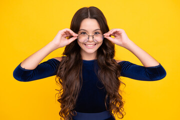 Happy face, positive and smiling emotions of teenager girl. Ophthalmologist tries on eyeglasses of teenager little girl, close-up. Treatment of childrens vision with glasses.