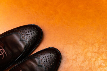 Brown brushed leather shoe with broguing