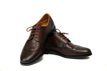 Brown brushed leather shoe with broguing in isolated white background.