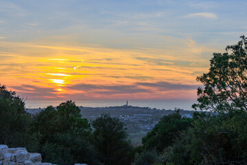 Obraz premium View from the ruins of the castle Kula Trnina to the town Rovij in Istria at sunset in the back light