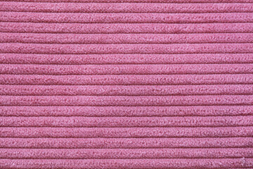 Closeup of pink corduroy cloth as patterned textured background