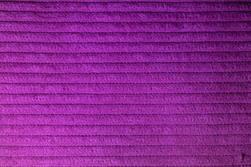 Closeup of pink corduroy cloth as patterned textured background