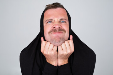 man hiding pulling sweater on head in displeasure, 