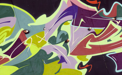 Colorful background of graffiti painting artwork with bright aerosol strips on metal wall. Old...